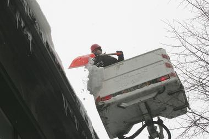 Nuo sniego gali įgriūti daugiabučių namų stogai